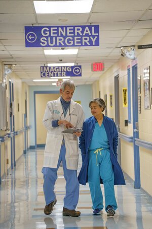 Surgical Services team smiling. There is one female and one male