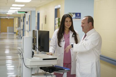Male Medical Professional and female Nurse standing next to each other